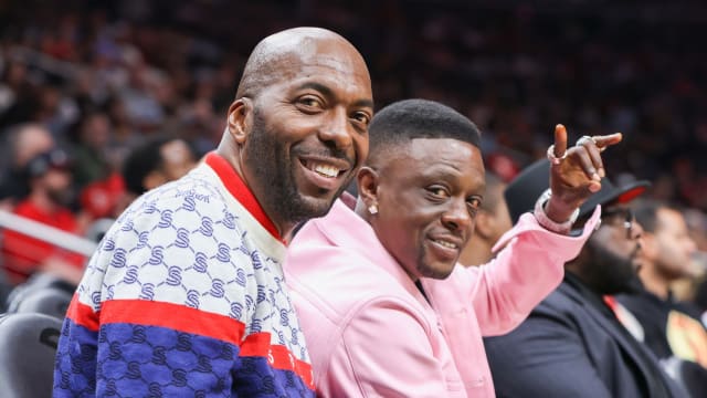 Former NBA player John Salley sits with rapper Boosie Badazz at a game between the Washington Wizards and Atlanta Hawks in the first half at State Farm Arena.